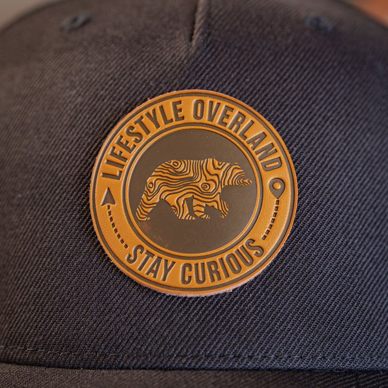Load image into Gallery viewer, Lifestyle Overland Topo Bear Wool Snapback Hat with Leather Logo Patch
